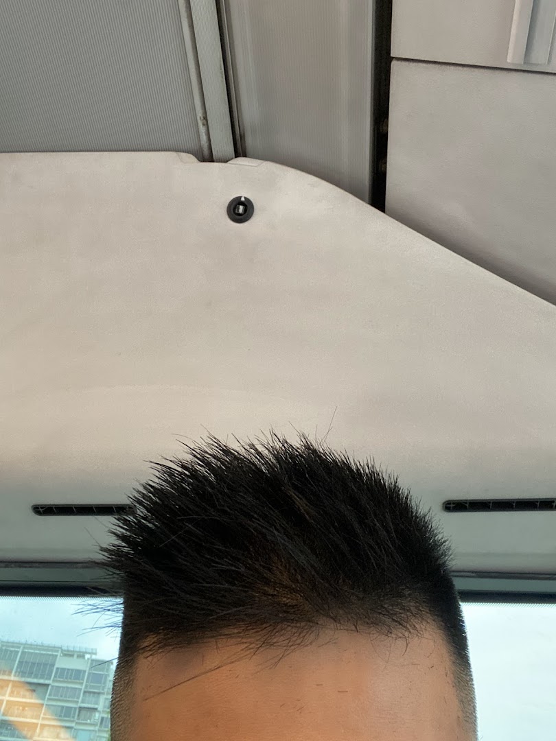 Close-up of a customer's spiky haircut, likely taken inside the kcuts salon.