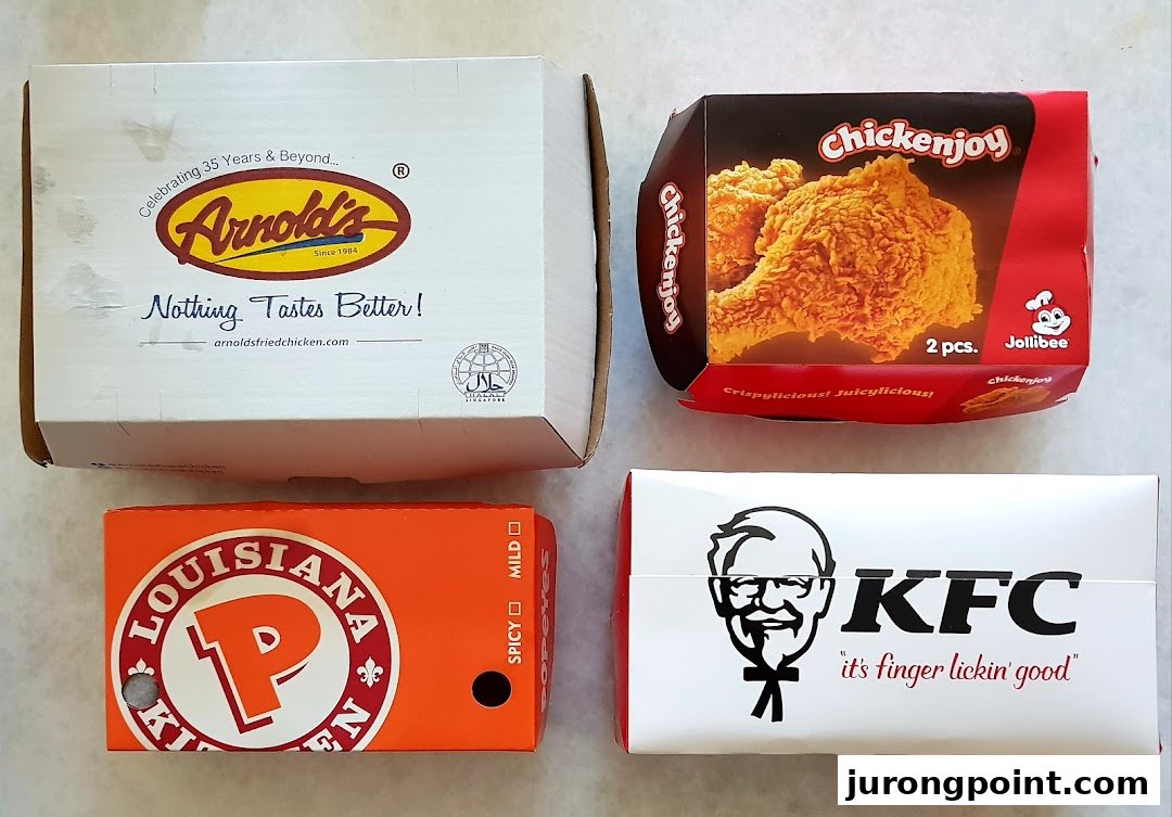 An overhead view of fried chicken packaging from Arnold's, Jollibee, Popeyes, and KFC.