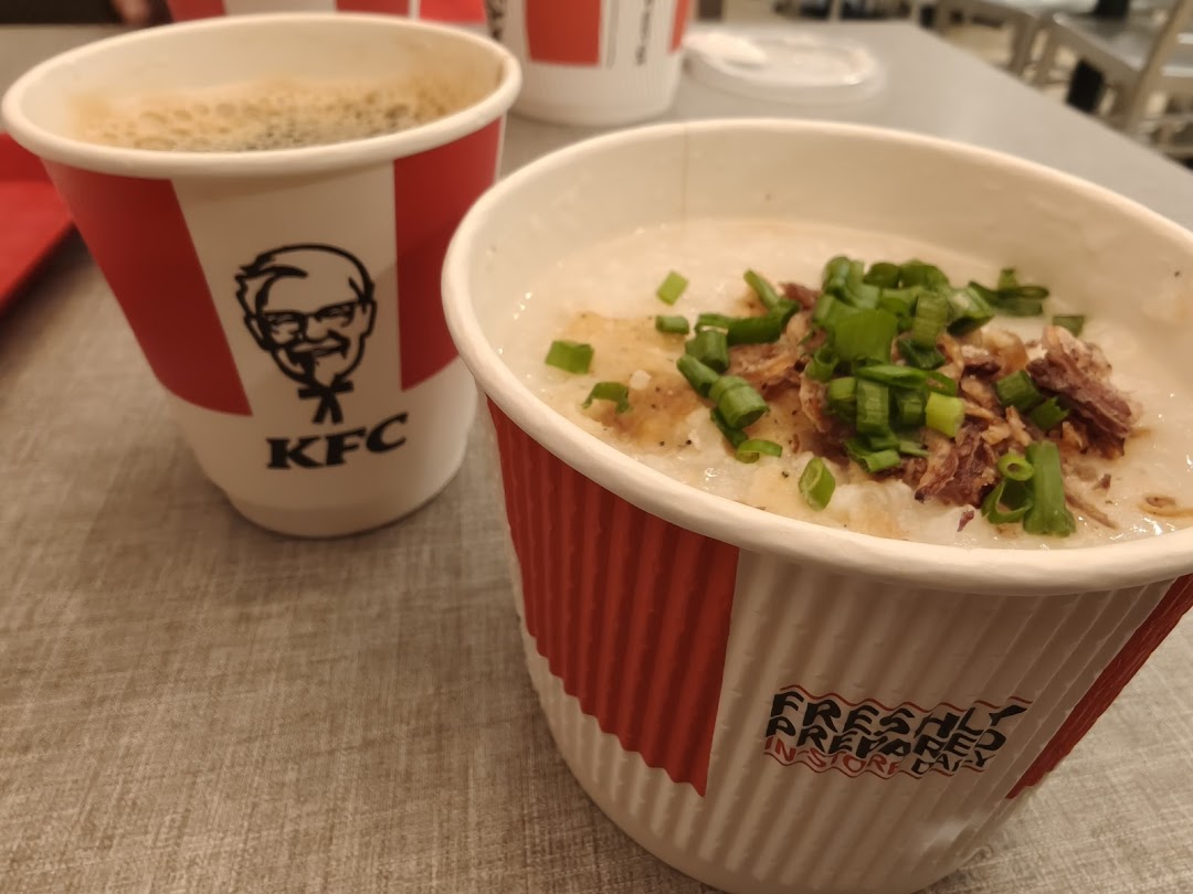 A cup of coffee and a bowl of congee/porridge with toppings from KFC.
