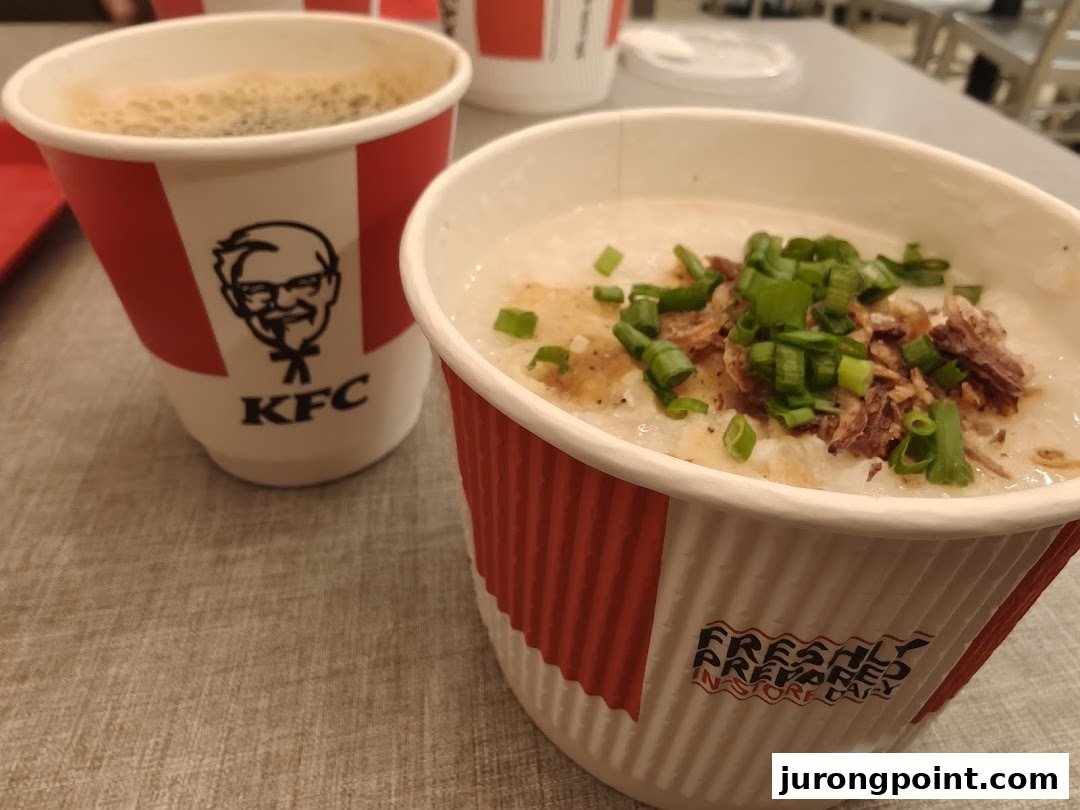 A cup of coffee and a bowl of congee/porridge with toppings from KFC.