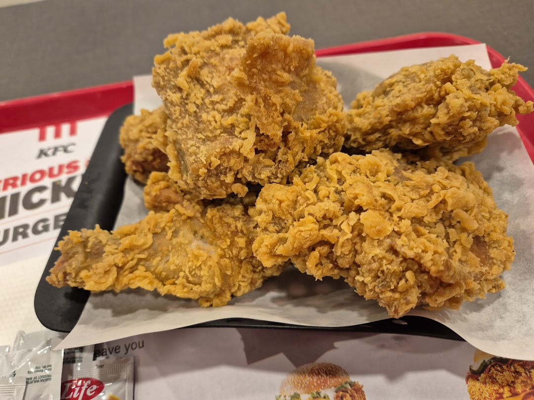 Close-up of crispy fried chicken pieces served on a tray at KFC.