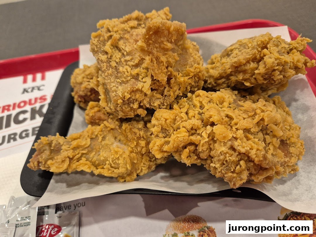 Close-up of crispy fried chicken pieces served on a tray at KFC.