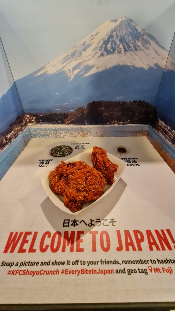 KFC's special fried chicken displayed against a scenic Mt. Fuji backdrop, inviting customers to 'Welcome to Japan!'.
