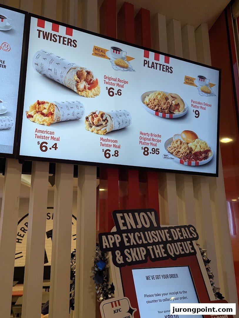 A digital menu board at KFC displaying various Twister and Platter meal options with prices.