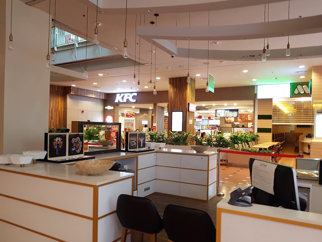 A view of the mall's dining area featuring KFC and other eateries in the background.