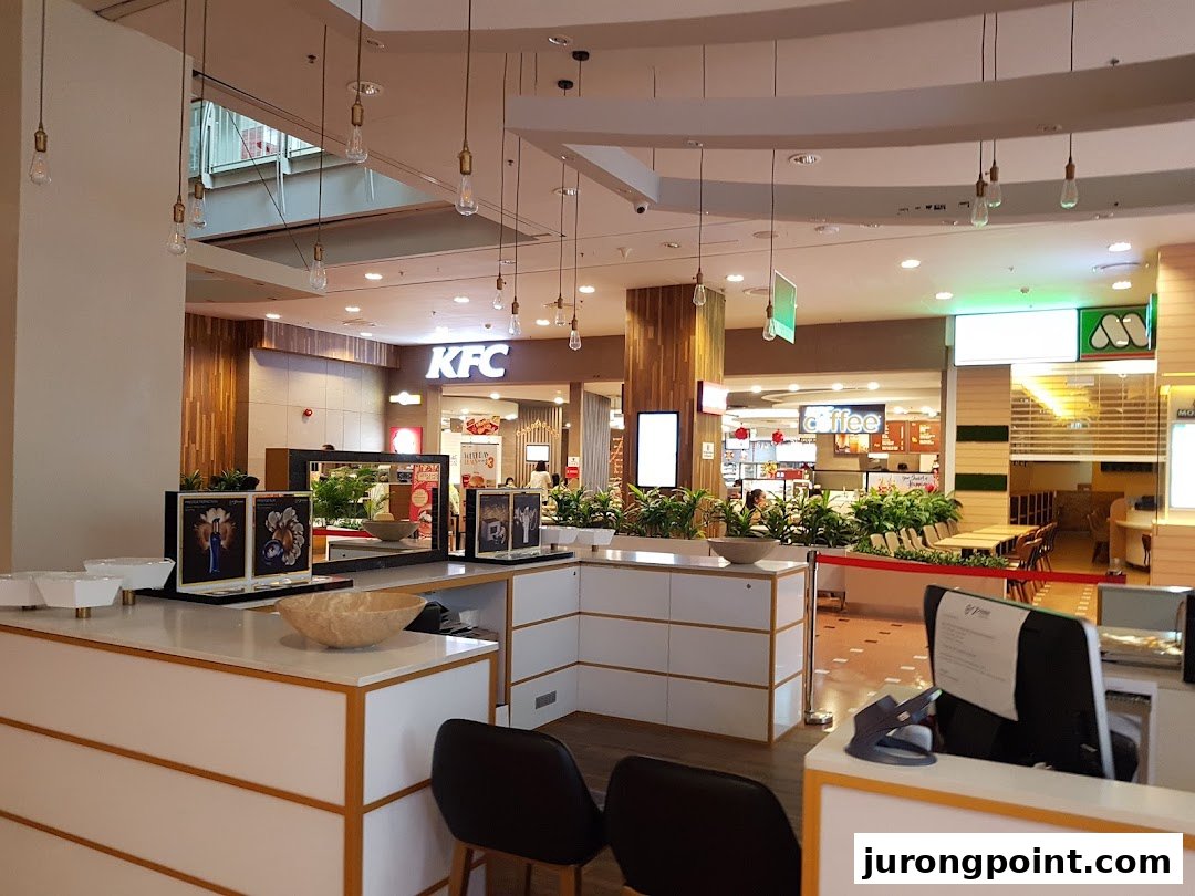 A view of the mall's dining area featuring KFC and other eateries in the background.