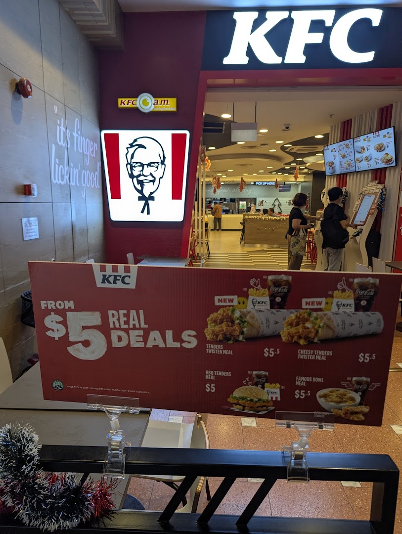KFC shop entrance featuring a promotional display for 'Real Deals' and a glimpse of the interior.