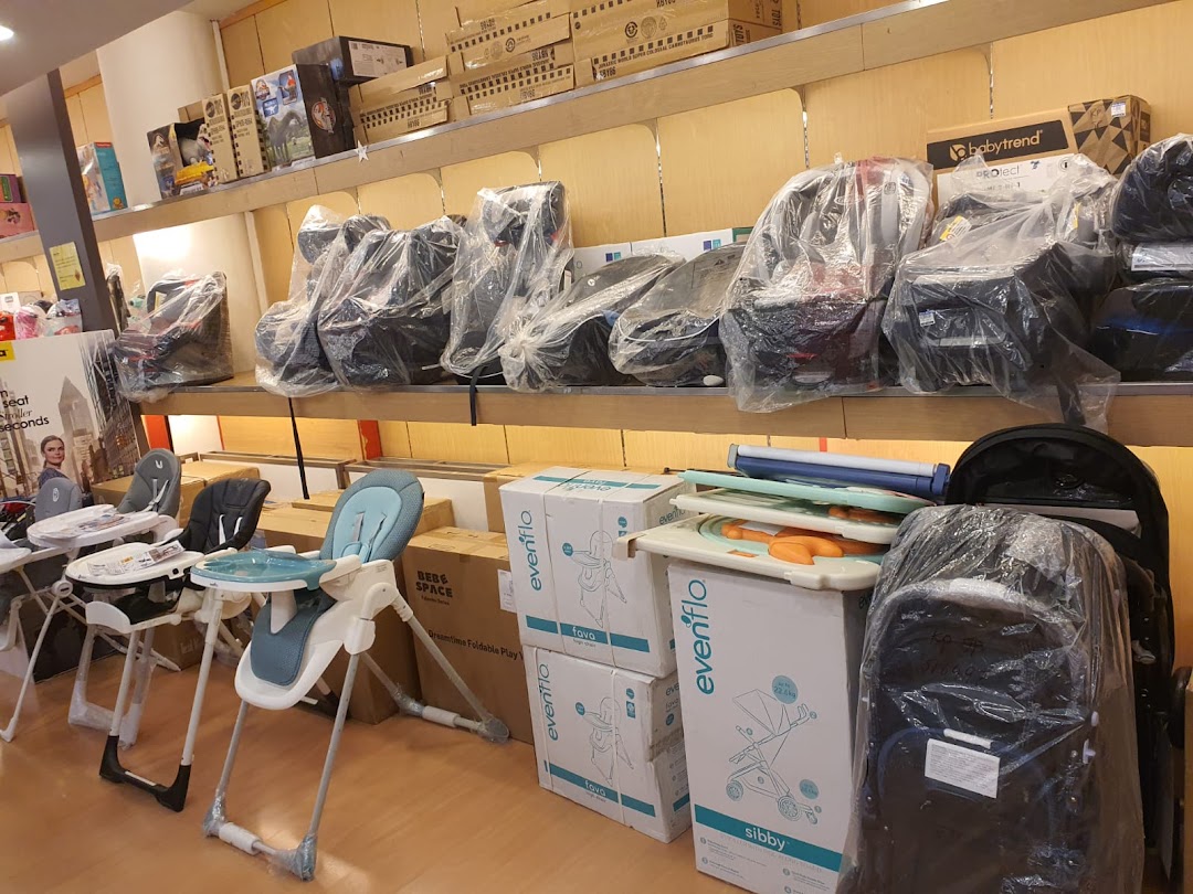An interior shot of Kiddy Palace showcasing baby car seats, high chairs, and strollers on display.