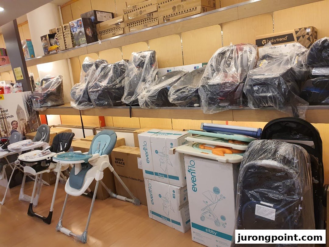 An interior shot of Kiddy Palace showcasing baby car seats, high chairs, and strollers on display.