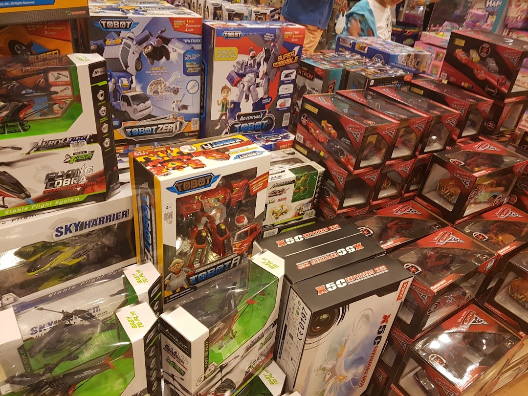 A vibrant display of various toys, including Tobot robots and remote-control vehicles, in a retail store.