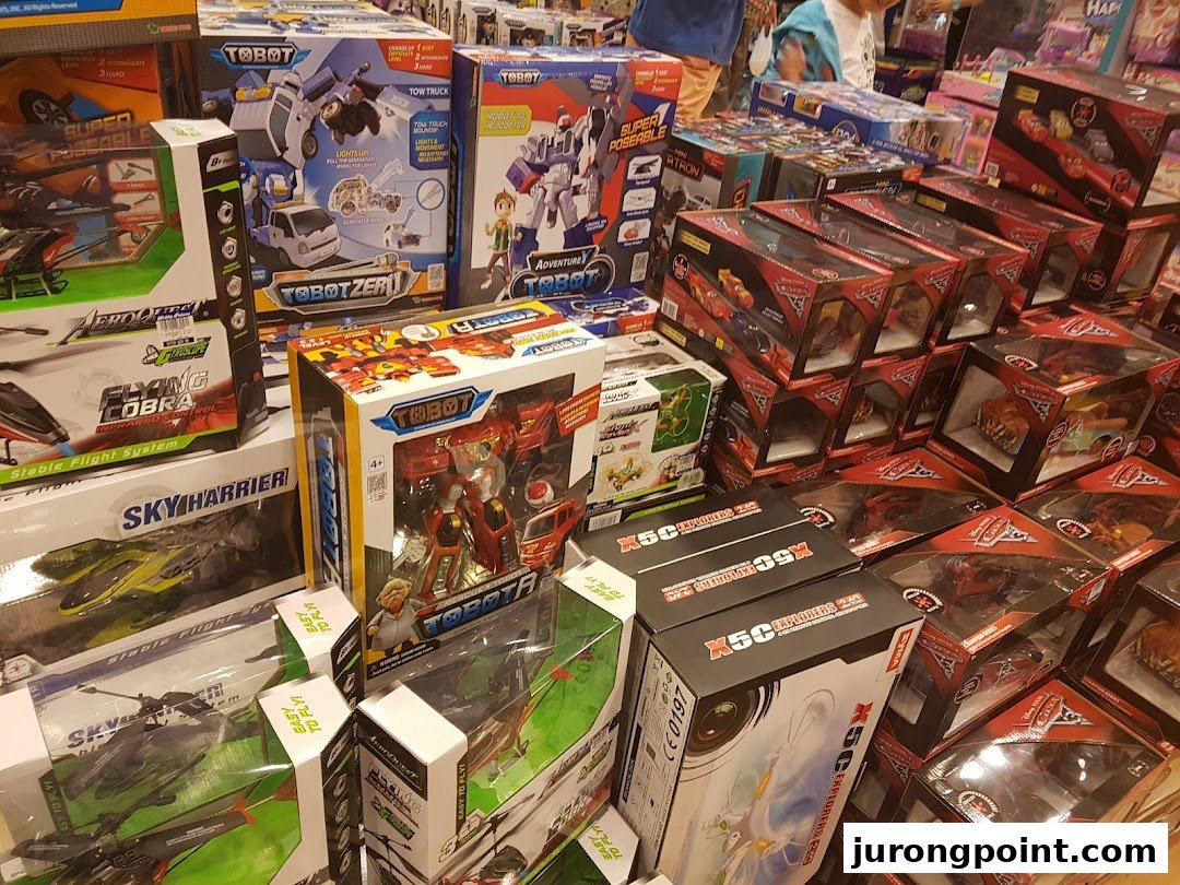 A vibrant display of various toys, including Tobot robots and remote-control vehicles, in a retail store.