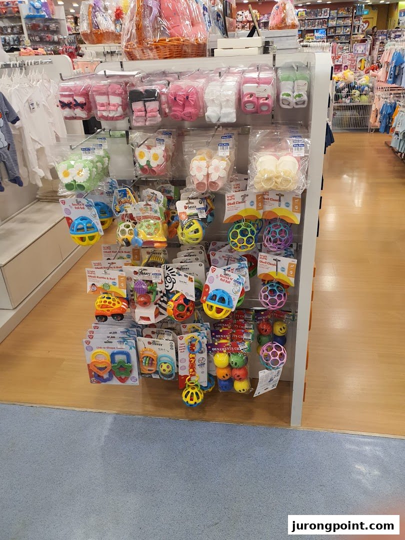 A display of colorful baby toys, rattles, and infant footwear at Kiddy Palace.