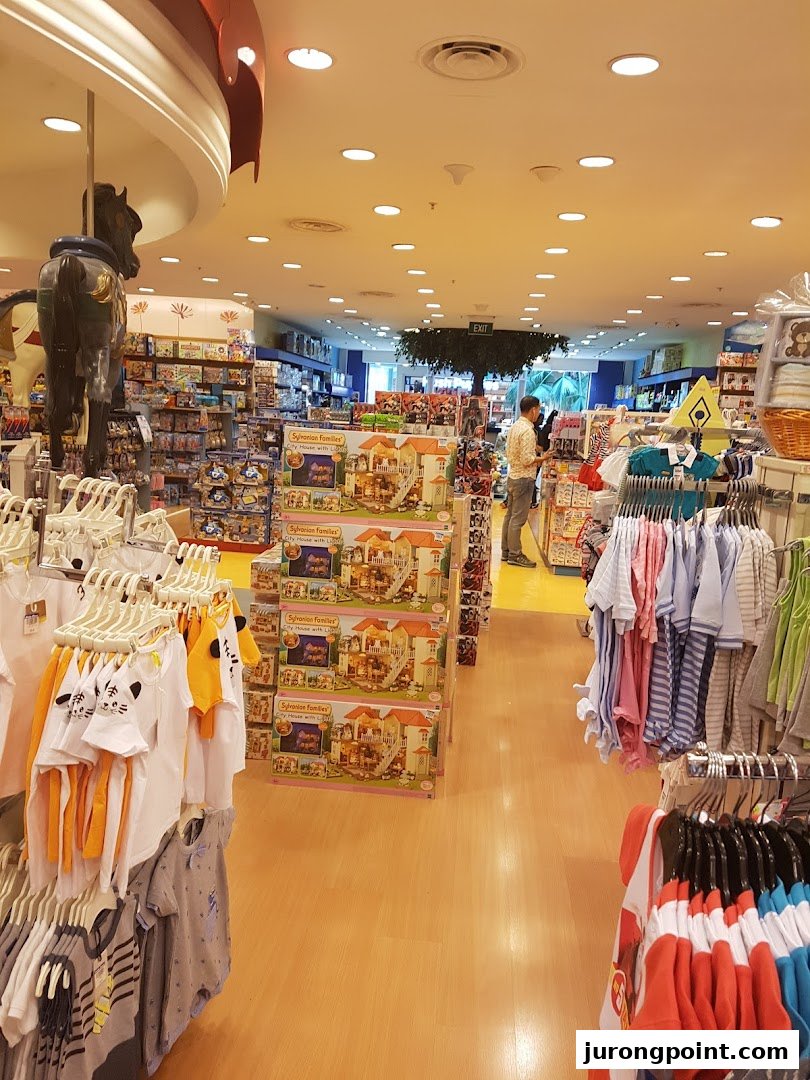 Vibrant interior of Kiddy Palace, showcasing children's apparel, Sylvanian Families toys, and a carousel horse.