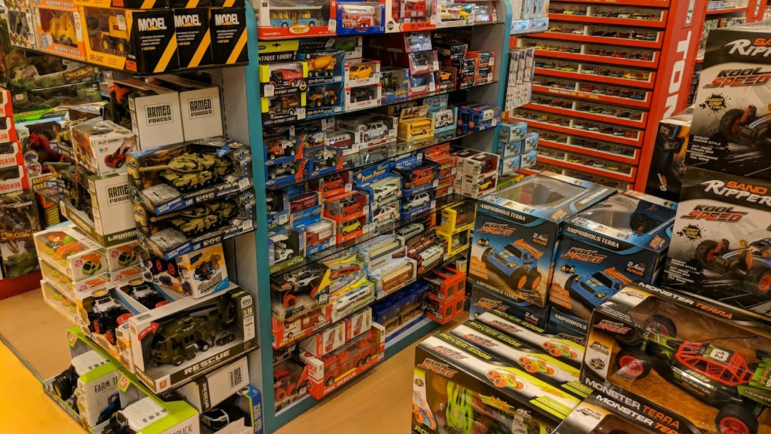 An interior shot of Kiddy Palace, showcasing shelves filled with a wide variety of toys, including model cars and remote control vehicles.