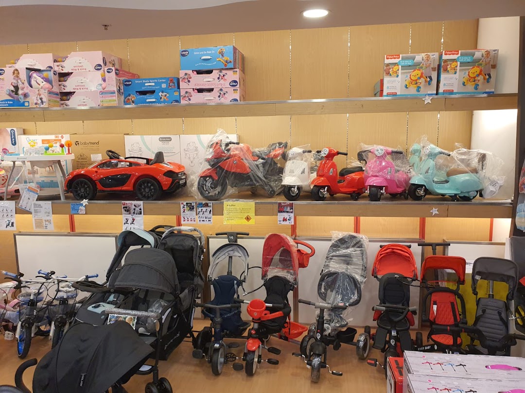 An interior shot of Kiddy Palace showcasing children's strollers, ride-on toys, and baby gear.