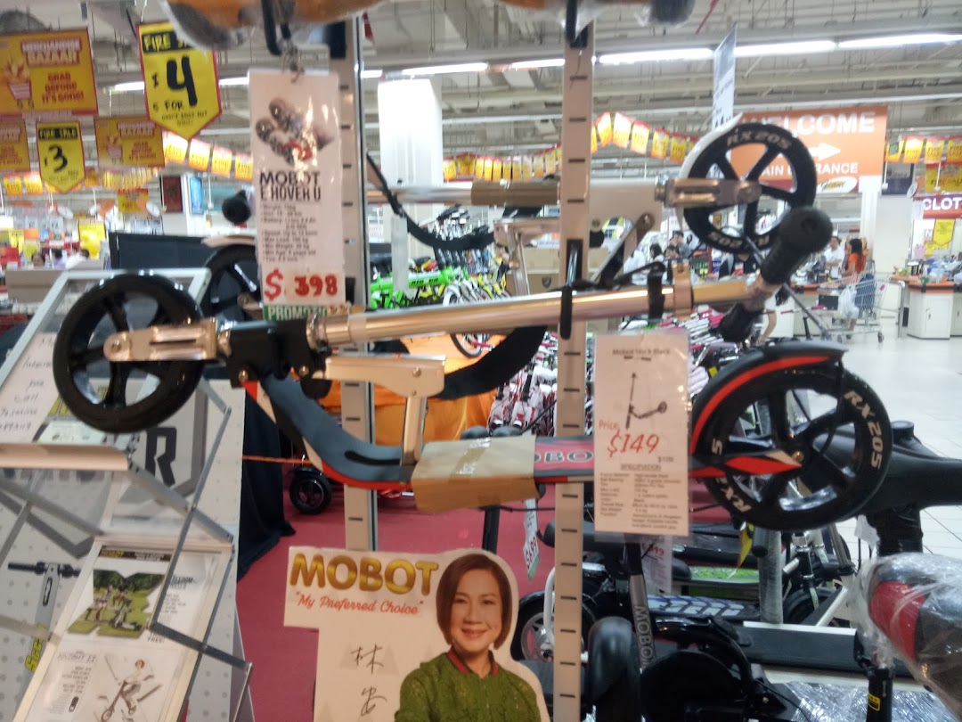 Mobility devices and scooters on display with price tags inside Kiddy Palace.