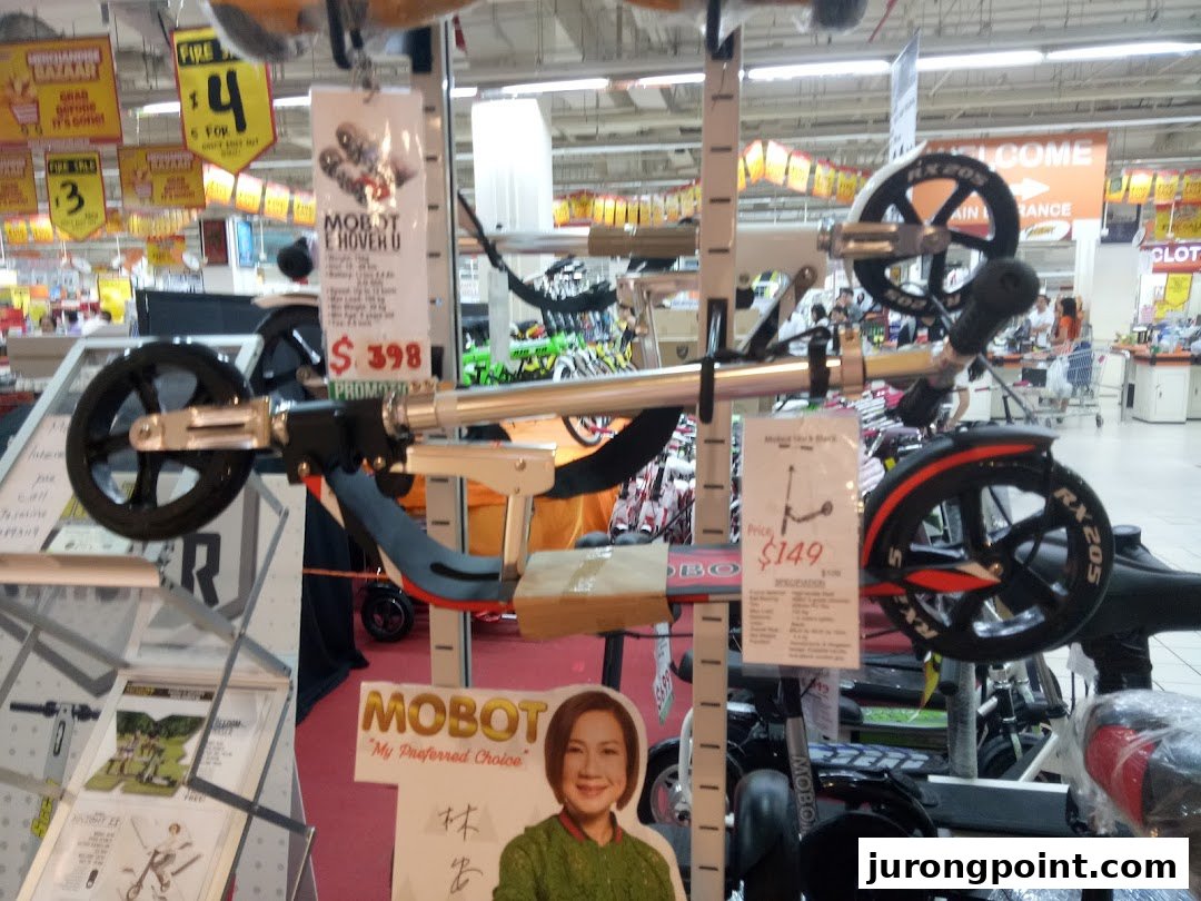 Mobility devices and scooters on display with price tags inside Kiddy Palace.