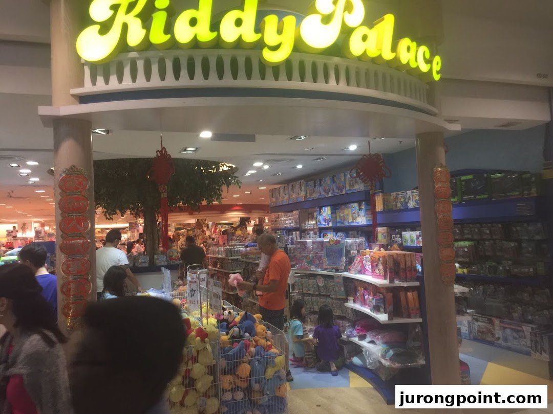 Entrance view of Kiddy Palace, a children's store, with customers browsing toys and products.