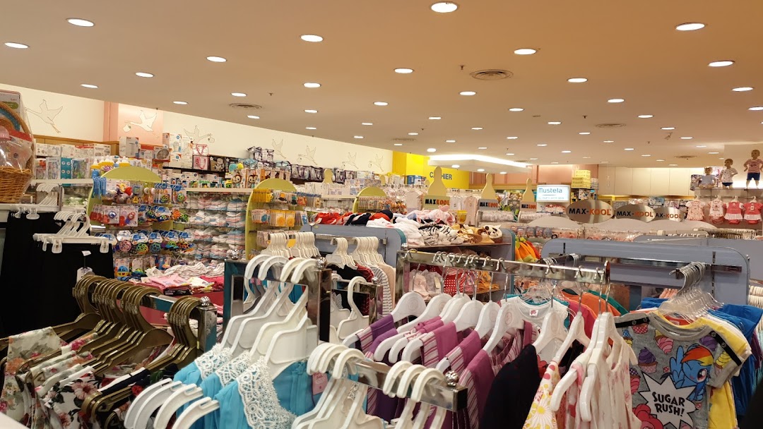 An interior view of Kiddy Palace, showcasing a wide array of baby and children's clothing, toys, and essential products.