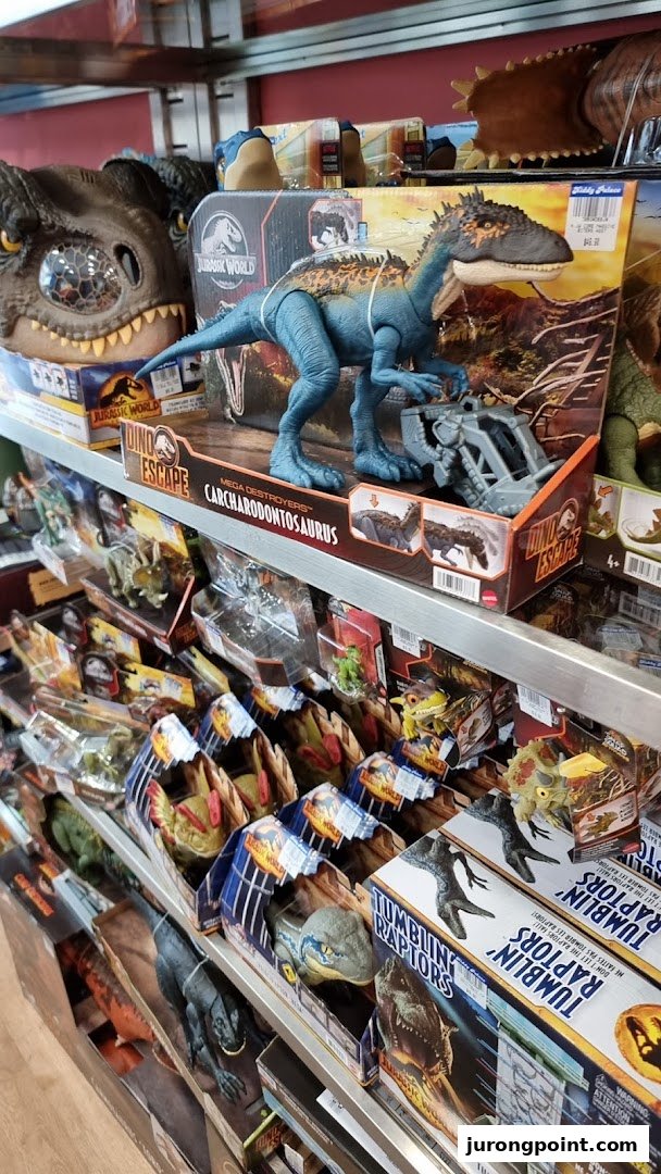 Shelves at Kiddy Palace filled with various Jurassic World dinosaur toys and action figures.