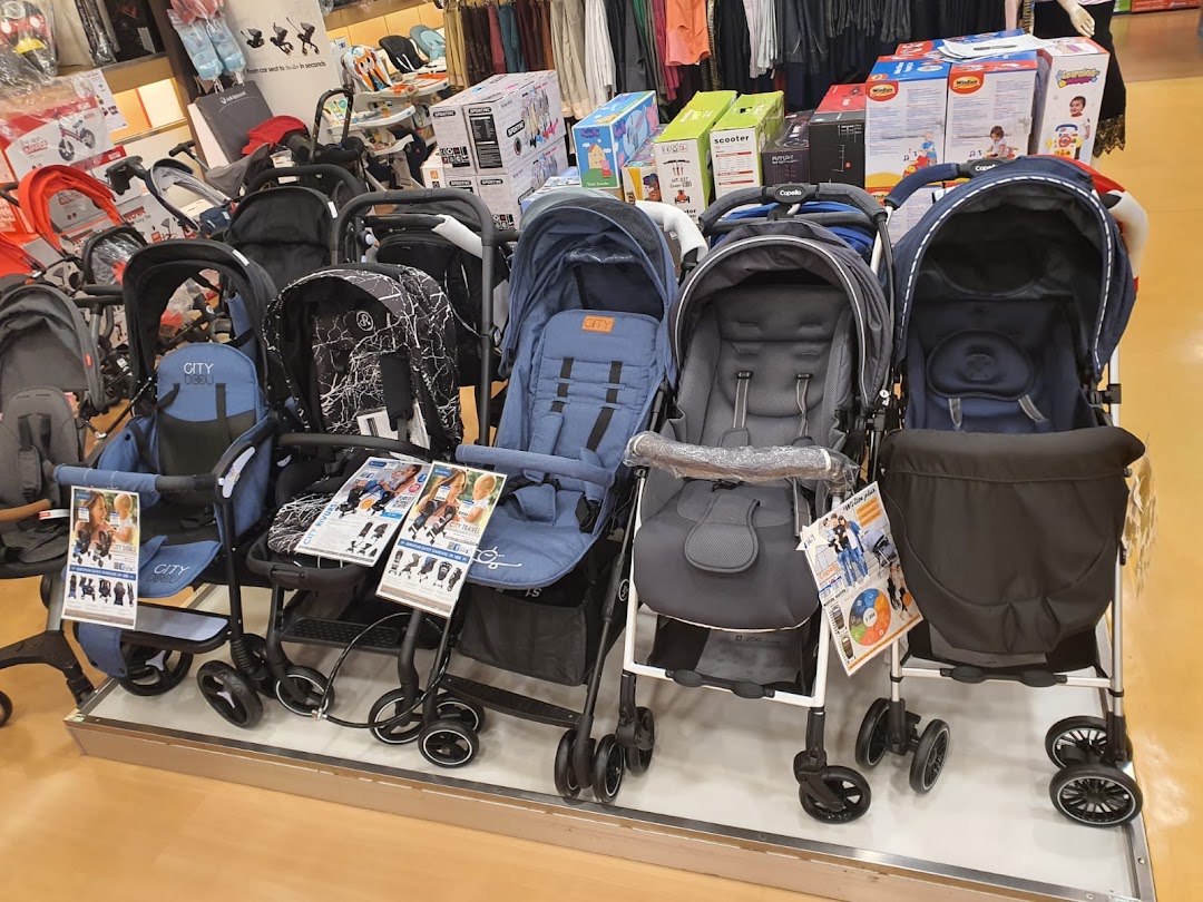 A wide selection of baby strollers and prams displayed in a retail store.