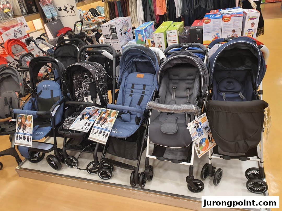 A wide selection of baby strollers and prams displayed in a retail store.