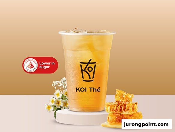 A refreshing honey-based drink from KOI Thé, highlighted as lower in sugar, with honeycomb and flowers.