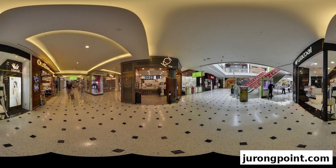The KOI Thé shop front in a brightly lit shopping mall corridor with other retail stores.