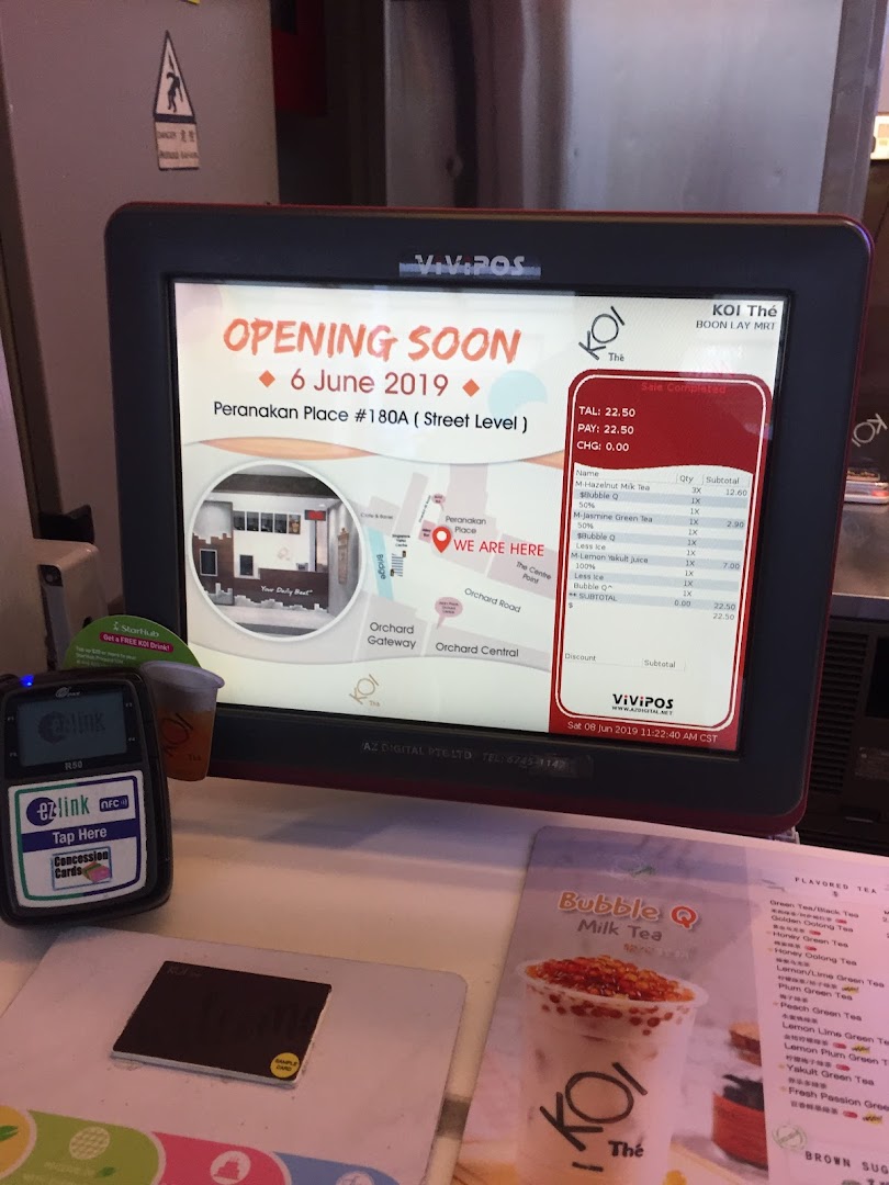 A KOI Thé point-of-sale system showing an opening announcement, transaction details, and payment terminal.
