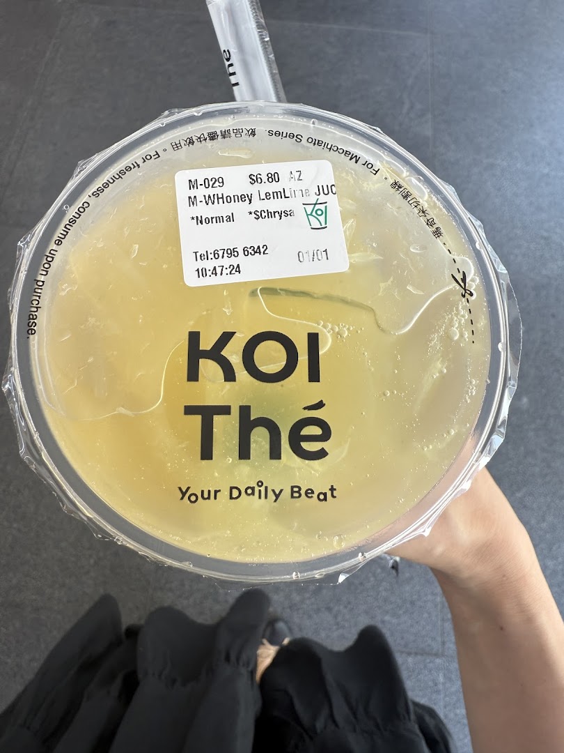 A top-down view of a refreshing honey lemon lime drink from KOI Thé, featuring the brand logo.