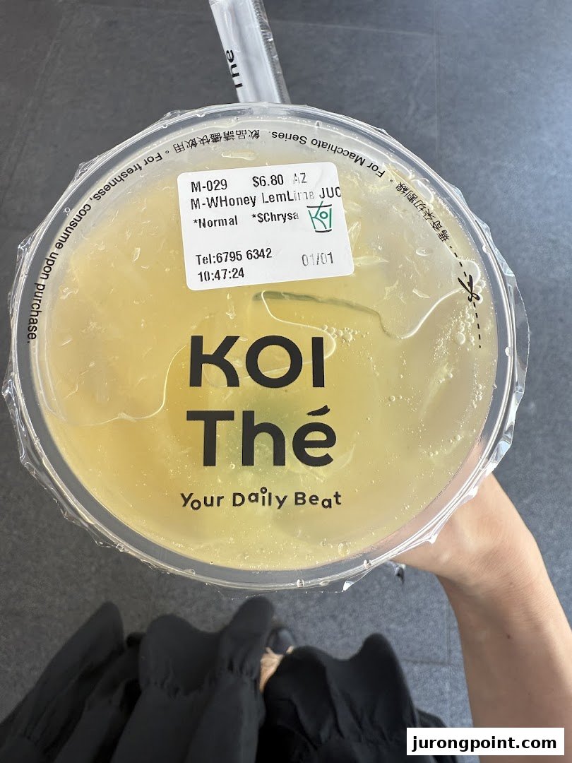 A top-down view of a refreshing honey lemon lime drink from KOI Thé, featuring the brand logo.