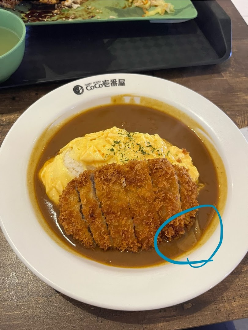 A delicious plate of Japanese curry with omelet and crispy katsu from CoCo Ichibanya.