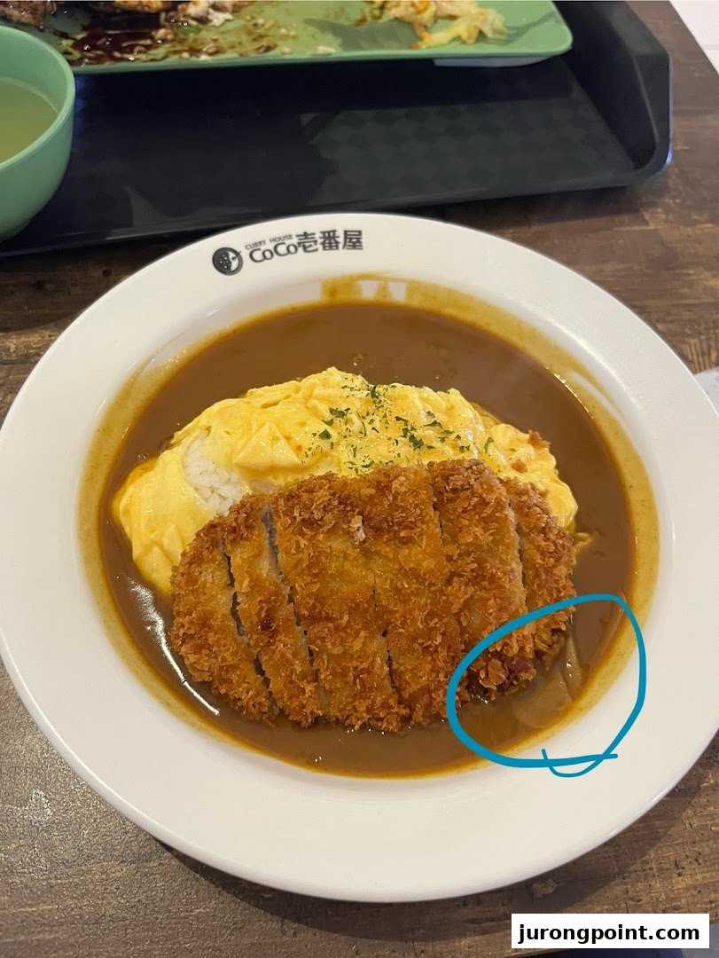 A delicious plate of Japanese curry with omelet and crispy katsu from CoCo Ichibanya.