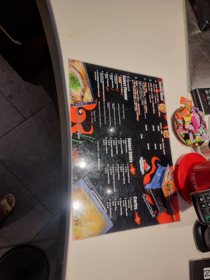 A detailed menu displaying various meal options, flavors, sides, and carbs on a counter.