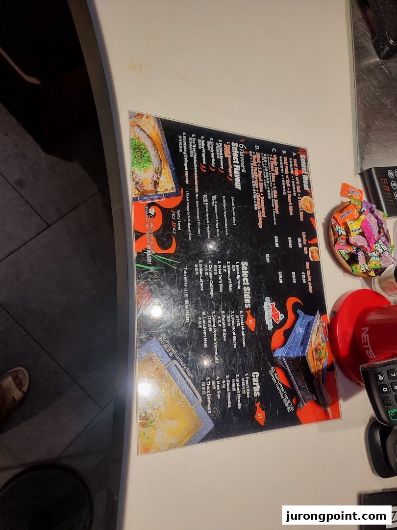 A detailed menu displaying various meal options, flavors, sides, and carbs on a counter.