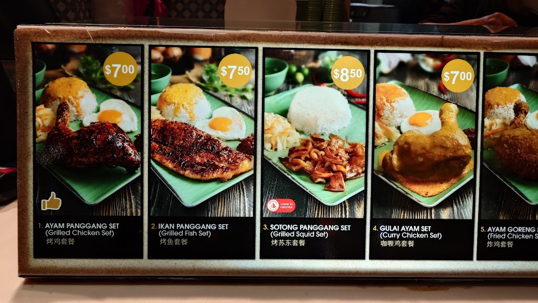 A vibrant menu board displaying various Asian-inspired grilled and fried chicken, fish, and squid sets.