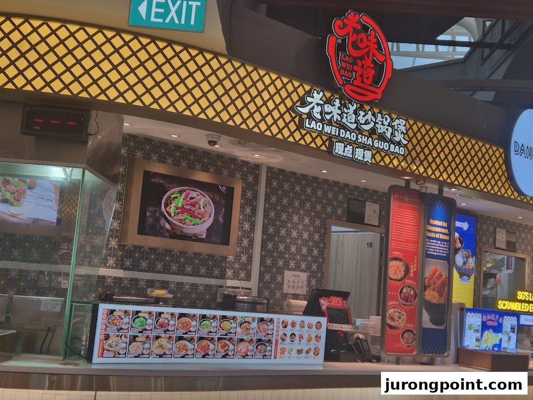 A food stall named Lao Wei Dao Sha Guo Bao in Kopitiam Food Hall, featuring a counter and food displays.