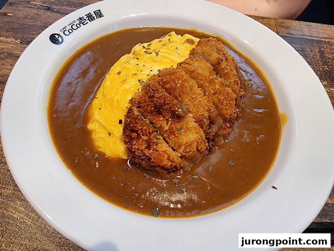 A delicious plate of Japanese curry with omurice and crispy tonkatsu.