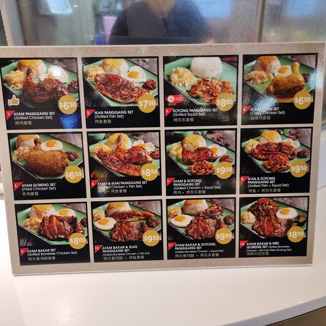 A vibrant menu board displaying various grilled and fried chicken, fish, and squid sets with prices.