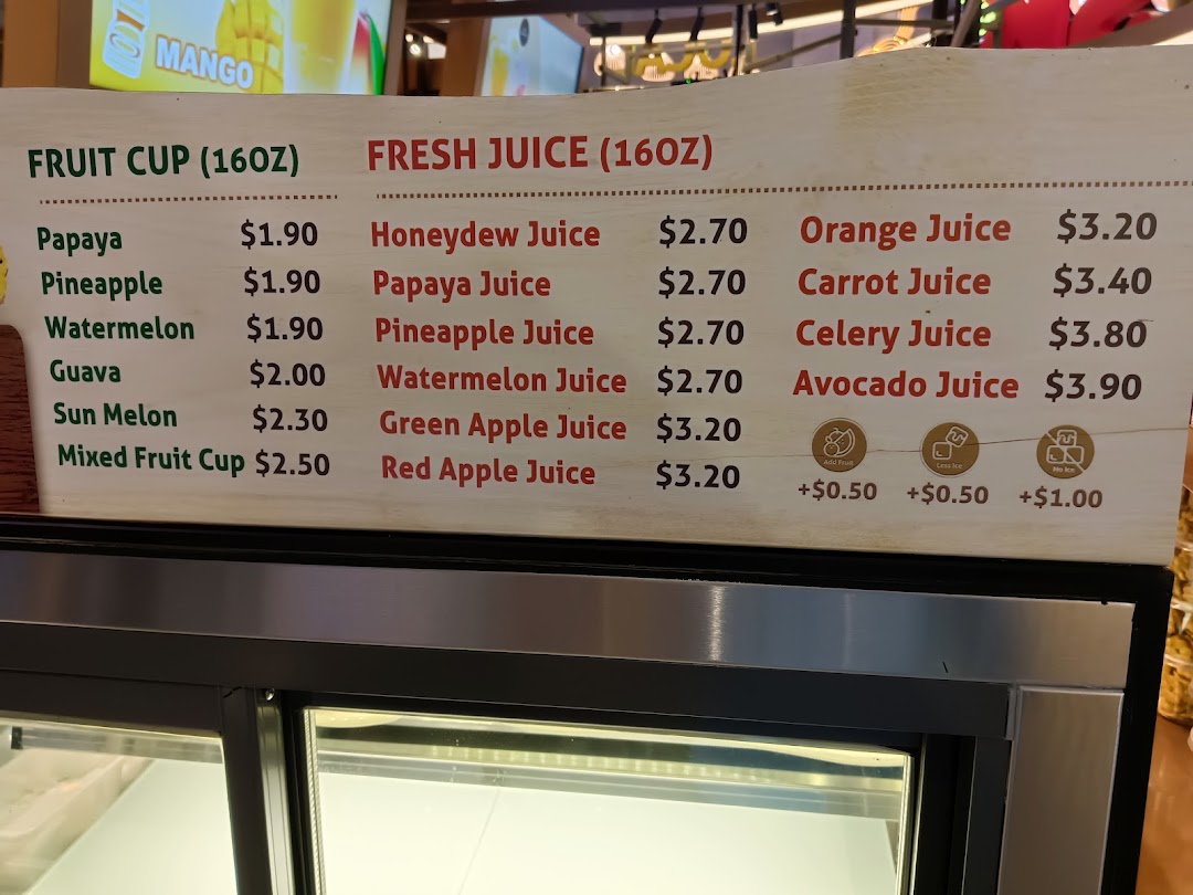 A menu board displaying prices for various fruit cups and fresh juices.