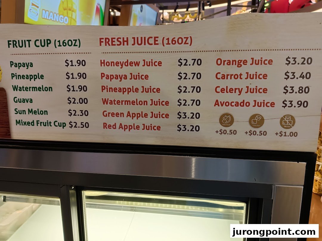 A menu board displaying prices for various fruit cups and fresh juices.