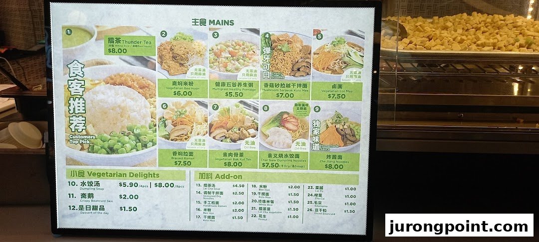A brightly lit menu board displaying various vegetarian mains, delights, and add-ons with prices.