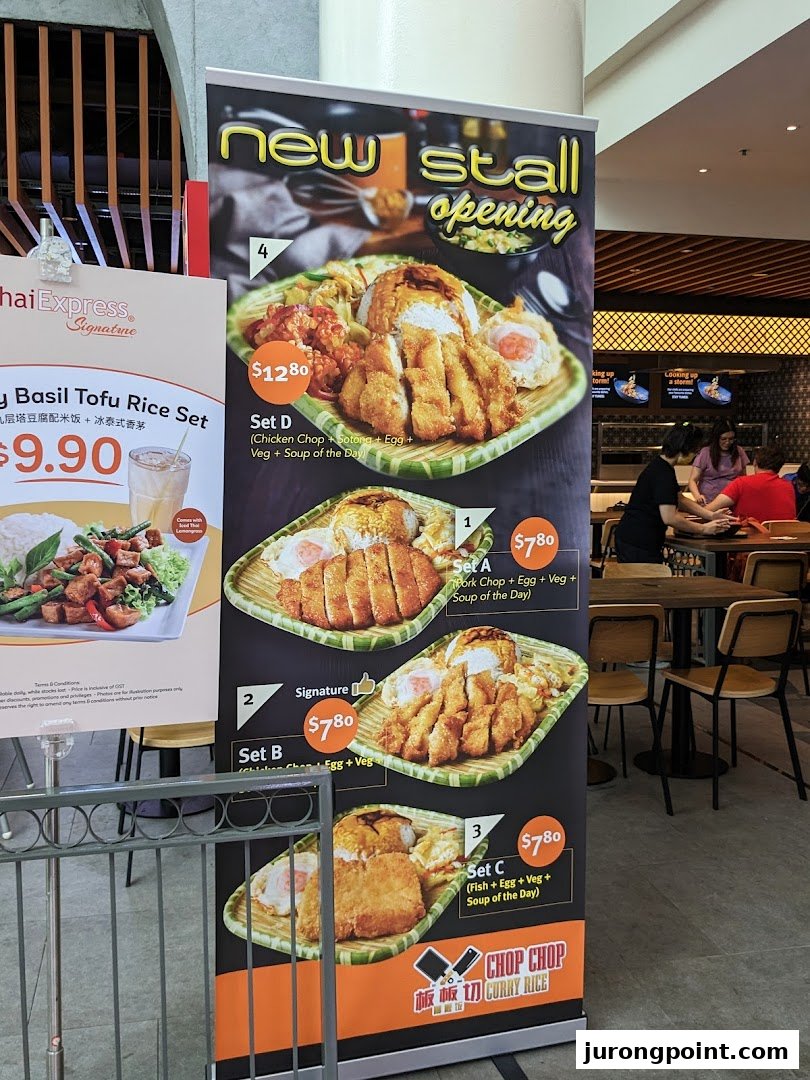 A menu standee showcasing various curry rice sets from Chop Chop Curry Rice and a Thai Express dish.