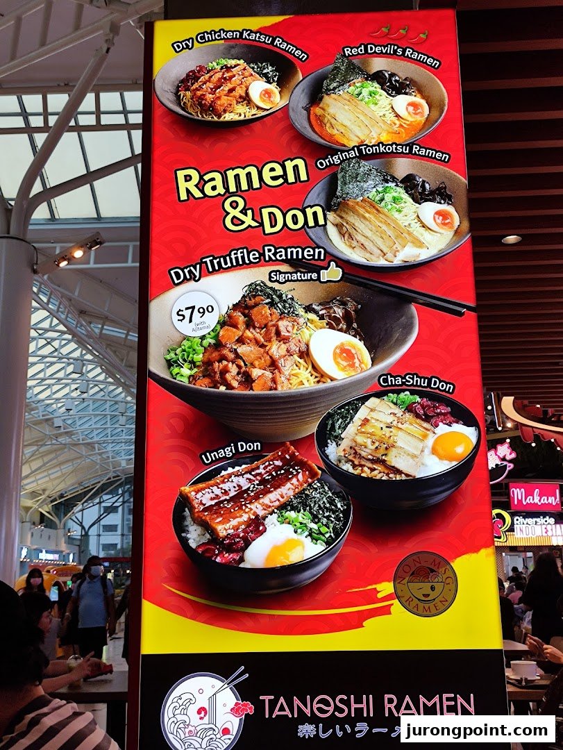 A vibrant menu board showcasing ramen and donburi dishes from Tanoshi Ramen.