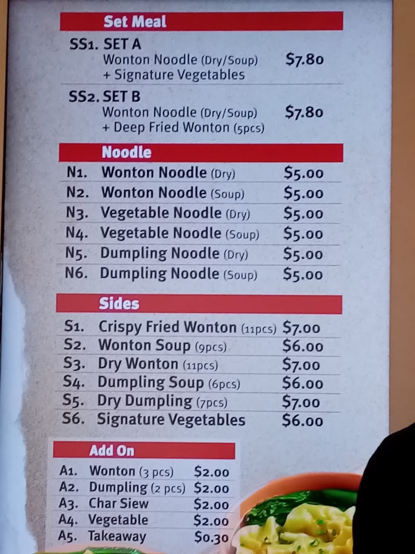 A detailed menu board displaying various noodle dishes, sides, and set meals with prices.