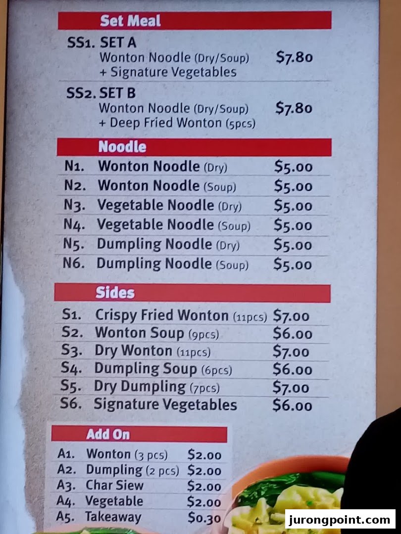 A detailed menu board displaying various noodle dishes, sides, and set meals with prices.