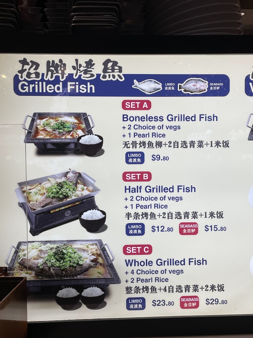 A menu board displaying various grilled fish sets with different fish types and accompaniments.