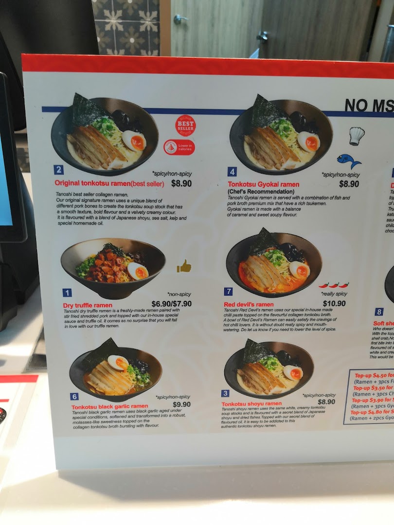 A detailed menu board displaying various ramen dishes with descriptions and prices.