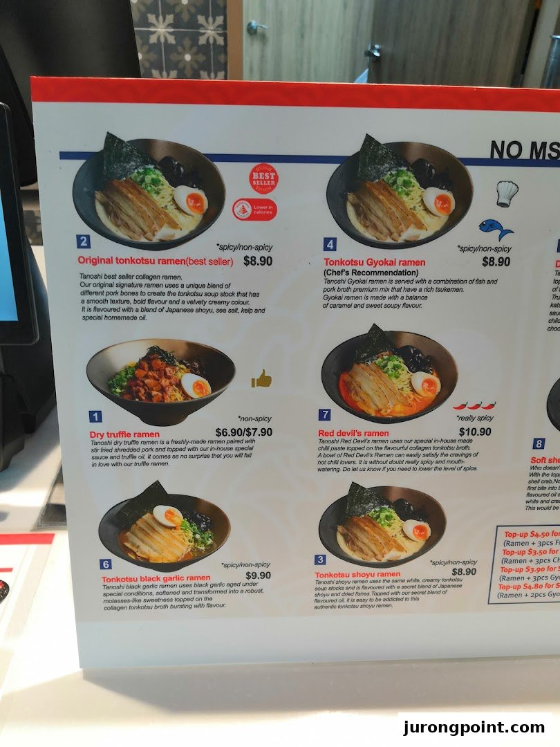 A detailed menu board displaying various ramen dishes with descriptions and prices.