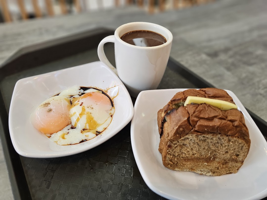 A classic Kopitiam breakfast set with soft-boiled eggs, kaya toast, and coffee.